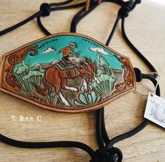 a brown horse with a man on it's back riding through the woods and holding a lasso