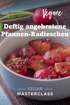 a white bowl filled with red vegetables on top of a wooden table next to radishes