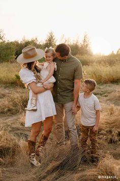 a family standing in the middle of a field