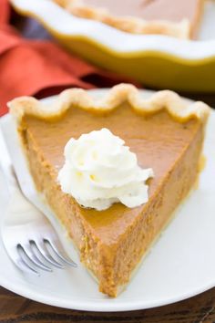 a slice of pumpkin pie with whipped cream on top