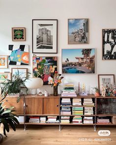 a living room filled with lots of furniture and pictures on the wall next to a window