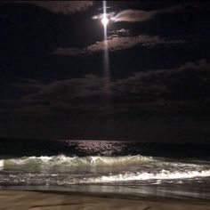 the moon is shining brightly over the ocean