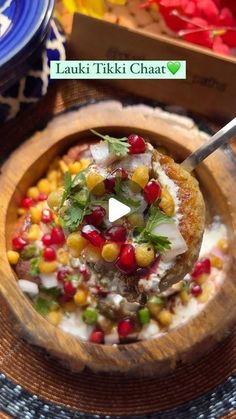 a wooden bowl filled with food on top of a table