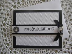 congratulations card with black and white ribbon on lace doily, next to two envelopes