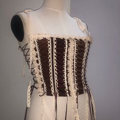 a woman's corset with white and brown trim