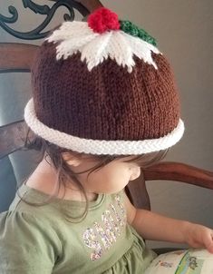 This fun and festive hand- knitted hat is perfect for your little one this holiday season. It's designed to look like a traditional Christmas fig pudding sitting atop a white platter. It's warm, cozy, and would look adorable in a holiday photo shoot. It has a rolled brim so there's room to grow!  Our hat model is 2 years old and wearing the 2-4 year old size. Sizes and Measurements: 0-6 months: Inner circumference 16-20 inches. 7.5 inches from crown to unrolled brim (not including berries). 1 ye Fig Pudding, Holiday Photo Shoot, Hat Model, Figgy Pudding, White Platter, Knitting For Charity, Holiday Photoshoot, Knit Christmas, Knitting Tips