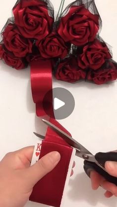 someone is cutting ribbon with scissors and roses