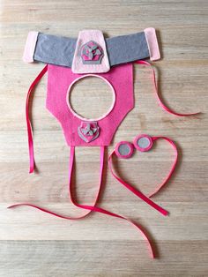 a child's hat and eyeglasses made out of felt on a wooden surface