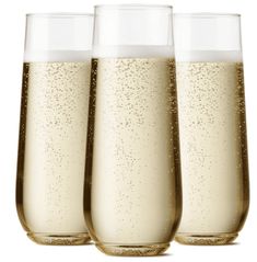 three champagne glasses filled with liquid on a white background