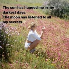 a woman kneeling in the middle of a field with pink flowers and text that reads, the sun has hugged me in my darkest days