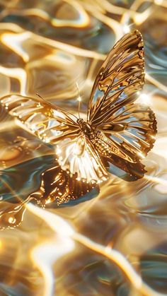 a golden butterfly floating on top of water with ripples in it's wings