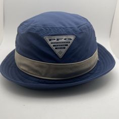 Stay Stylish And Protected From The Sun With This Men's Columbia Pfg Slack Tide Bucket Hat. The Blue Hat Features A Solid Pattern, Outdoor Theme, And Uv Protection. It Is Made Of Polyester Material And Has A Size Of S/M. The Bucket Hat Is Perfect For Casual Occasions And Is Not Signed Or Handmade. The Columbia Brand Is Known For Its Quality Products, And This Hat Is No Exception. It Is Made In Vietnam And Has Features Such As Upf 50, Making It A Great Choice For Fishing Or Outdoor Activities. Ge Blue Six-panel Hat For Outdoor, Adjustable Blue Outdoor Bucket Hat, Blue 5-panel Dad Hat For Outdoor, Blue 5-panel Snapback Hat For Outdoor, Adjustable Upf 50+ Bucket Hat For Fishing, American Flag Sweater, Adidas Track, Columbia Blue, Swim Shoes