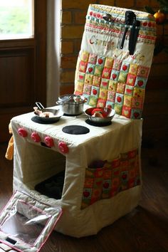 a stove top oven sitting on top of a wooden floor next to a christmas tree