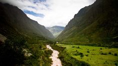 a river running through a lush green valley