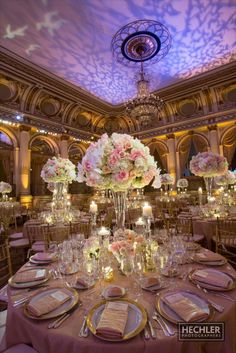 the tables are set with flowers and candles for an elegant wedding reception at the grand america hotel