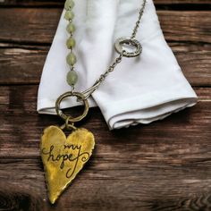 Embrace The Beauty Of Faith With This Stunning Dayspring Christian Necklace. The Asymmetrical Design Exudes Boho Chic Vibes, With A Mix Of Silver And Bronze Elements. The Bronze Heart Is Etched With "My Hope," While The Silver Circle Bears The Message "His Unfailing Love." Adorned With Pale Green Beads, This Necklace Is A Truly Unique Piece That Captures The Essence Of Faith And Love. New In Plastic Bag That It Was Purchased In. Silver Bohemian Necklace For Spring, Ava Quotes, Unfailing Love, Boho Chic Design, Christian Necklace, Faith Jewelry, Chic Vibes, My Hope, Green Beads