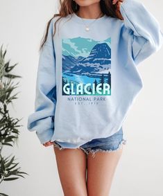 Cute Glacier Park Sweatshirt. This cozy unisex Gildan crewneck National Park Sweatshirt is just what you need for any hiking, camping, lounging, or road tripping adventure. Super soft and comfy, featuring a colorful retro style graphic to love and wear for years to come. If you'd like a more roomy oversized fit, don't forget to size up! Glacier National Park Sweatshirt | Cozy Retro National Park Gift Printed on a classic unisex Gildan cotton sweatshirt. Colors: Light Blue *AVAILABLE in more styl National Park Sweatshirt, Washington Vacation, Shirt Printer, Sweatshirt Colors, National Park Gifts, National Park Shirt, Mount Rainier National Park, Smoky Mountain National Park, Glacier National