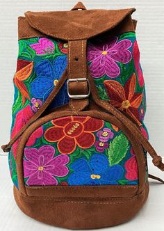 1 of a kind backpack Hand made by artisan's in Guatemala Each backpack has its unique embroidery pattern due to the handmade nature.   * Front Zipper pocket  * Adjustable straps  * Belt buckle closure  * Floral Embroidery  Perfect for traveling, hiking, or for a gift for someone special!  Approximate Measurements  L x W x D 11 in. x 12 in. x 5 in. Handmade Multicolor Travel Backpack, Handmade Outdoor Backpack, Handmade Outdoor Standard Backpack, Artisan Backpack For Travel, Artisan Travel Backpack, Artisan Backpack For Daily Use, Embroidered Rectangular Backpack For Travel, Travel Shoulder Bag With Multicolor Embroidery, Embroidered Backpack For Travel