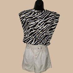 Everlynn Apparel Zebra Shoulder Pad Tank Top. 95% Polyester , 5% Spandex Size Amall Bust = 40" Length 23.5" White Zebra Print Tops For Summer, White Zebra Print Casual Tops, Casual Sleeveless Zebra Print Top, Trendy Zebra Print Summer Top, Spring Zebra Print Tops For Beach, Spring Beach Zebra Print Tops, Chic Summer Tops With Zebra Print, Casual Stretch Zebra Print Top, Casual White Tank Top For Night Out