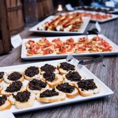 several trays filled with different types of appetizers