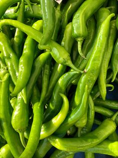 green peppers are piled on top of each other