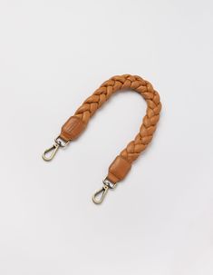 Add some pizzazz to any outfit with this braided shoulder strap. Crafted from our luxurious soft grain leather, this strap transforms any bag into a chic shoulder bag with our convenient hooks. Want to know our favorite pairing? It's our Leo bag. OMB-braidedstrapq Kids Stationary, Sustainable Leather, Stained Glass Suncatchers, Antique Brass Hardware, Sunglasses Shop, Braided Leather, Hat Hairstyles, Ring Bracelet, Shoulder Handbags