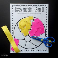 a piece of paper cut out to look like a beach ball with scissors and tape