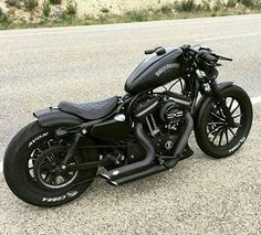 a black motorcycle is parked on the side of the road