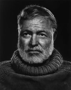 an old man with a beard wearing a sweater