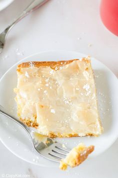 a piece of cake sitting on top of a white plate with a fork next to it