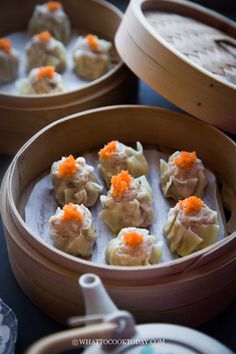 some dumplings with carrots are in a wooden container