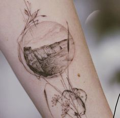 an artistic tattoo on the arm of a woman