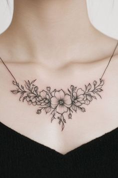 a woman's chest with flowers and leaves on the back of her neck,