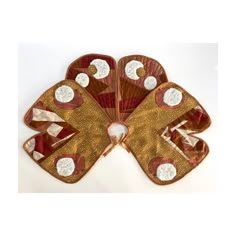 three hand fan shaped like flowers on top of each other in gold and red colors