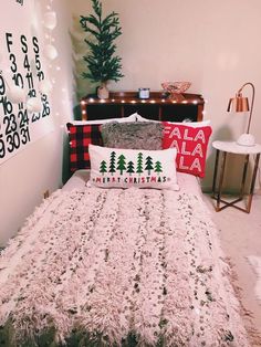 a bed with christmas decorations and lights on the headboard