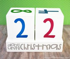 two blocks with numbers on them that say 2 and 3 days until christmas, sitting on a wooden table