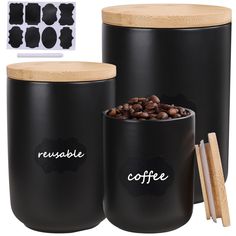 two black canisters with coffee beans and chopsticks next to each other