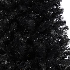 a black christmas tree with snow on it