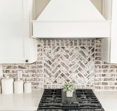 a stove top oven sitting inside of a kitchen next to a white counter and cabinets