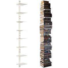 a tall white book shelf next to a stack of books on top of each other