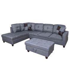 a gray sectional couch with ottoman and footstool in front of a white background