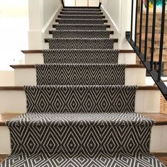 the stairs are decorated with black and white rugs, which is an interesting pattern