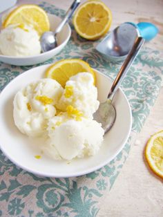 two plates filled with ice cream and lemons on top of a blue table cloth