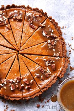 a chocolate pie with nuts and caramel on top