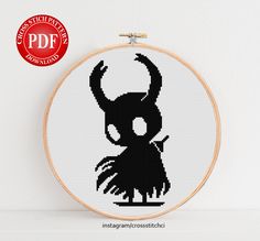 a cross stitch pattern with a black and white image of an evil - looking demon