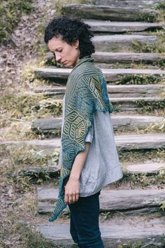 a woman walking up some steps with her hand on her hip and looking down at the ground