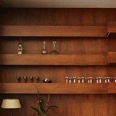 a living room filled with lots of wooden shelves and vases on top of it