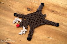 a crocheted stuffed animal laying on top of a wooden floor