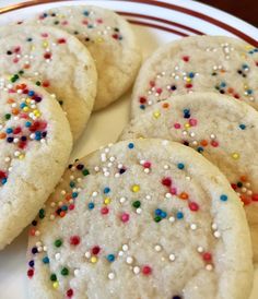 white cookies with colorful sprinkles on a plate