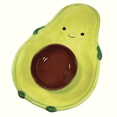 an avocado shaped bowl with chocolate in the center and eyes drawn on it